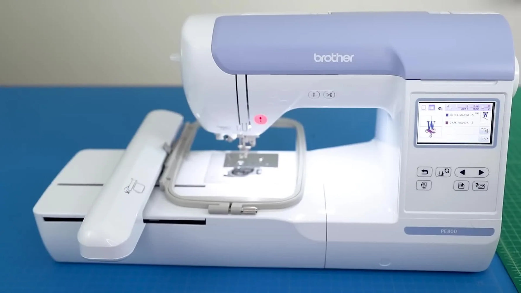 A clear product shot of the Brother PE800 embroidery machine set on a cutting mat, ready for setup.