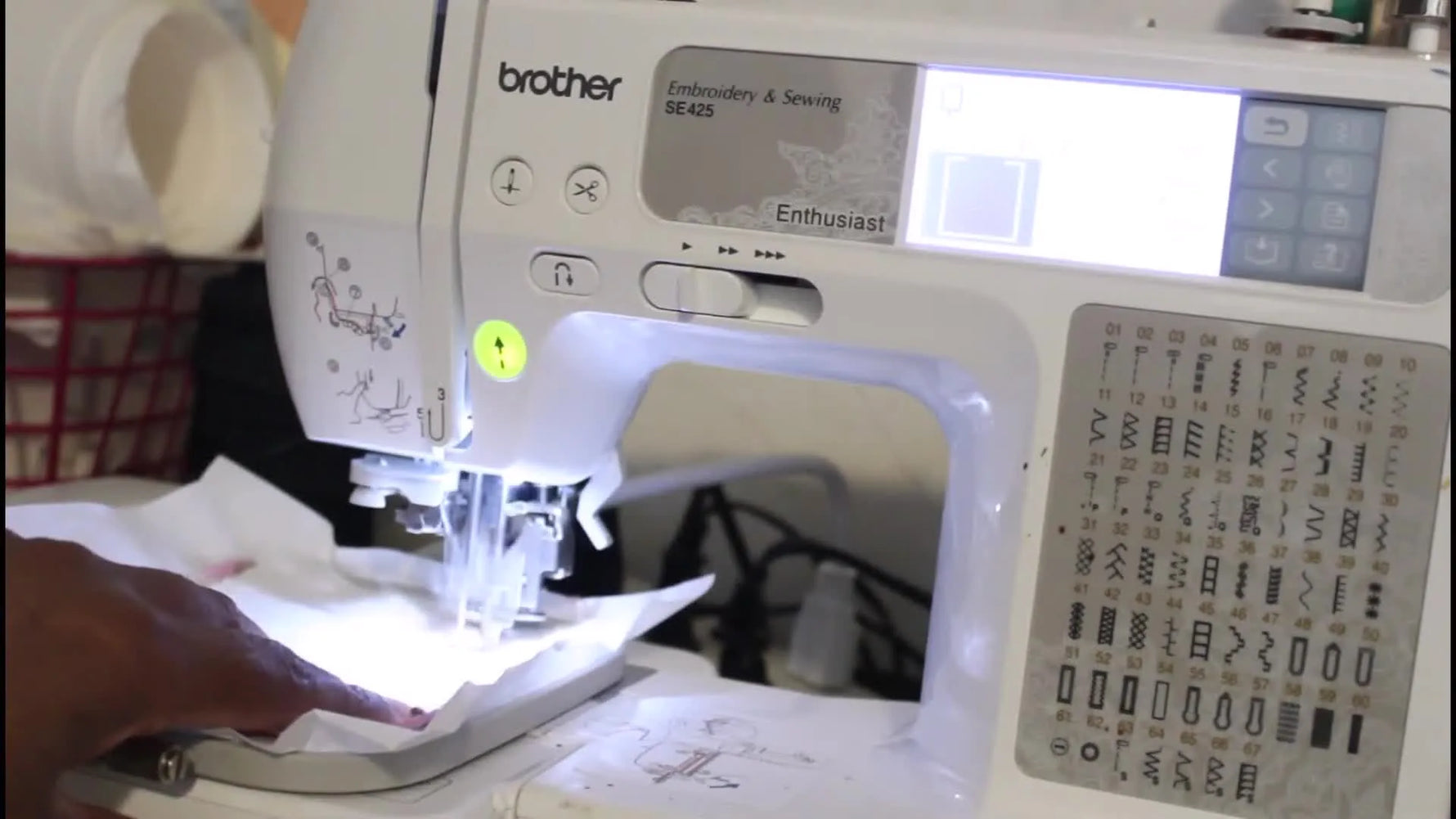 Close-up of the Brother SE425 stitching the coaster seam through a floated fabric-and-batting stack in the 4x4 hoop.