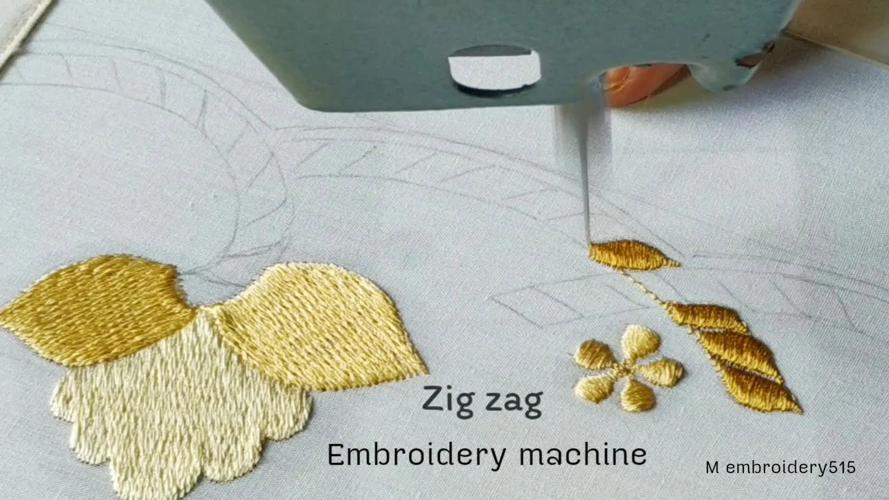 An overhead shot showing an embroidery machine needle working on a white fabric.