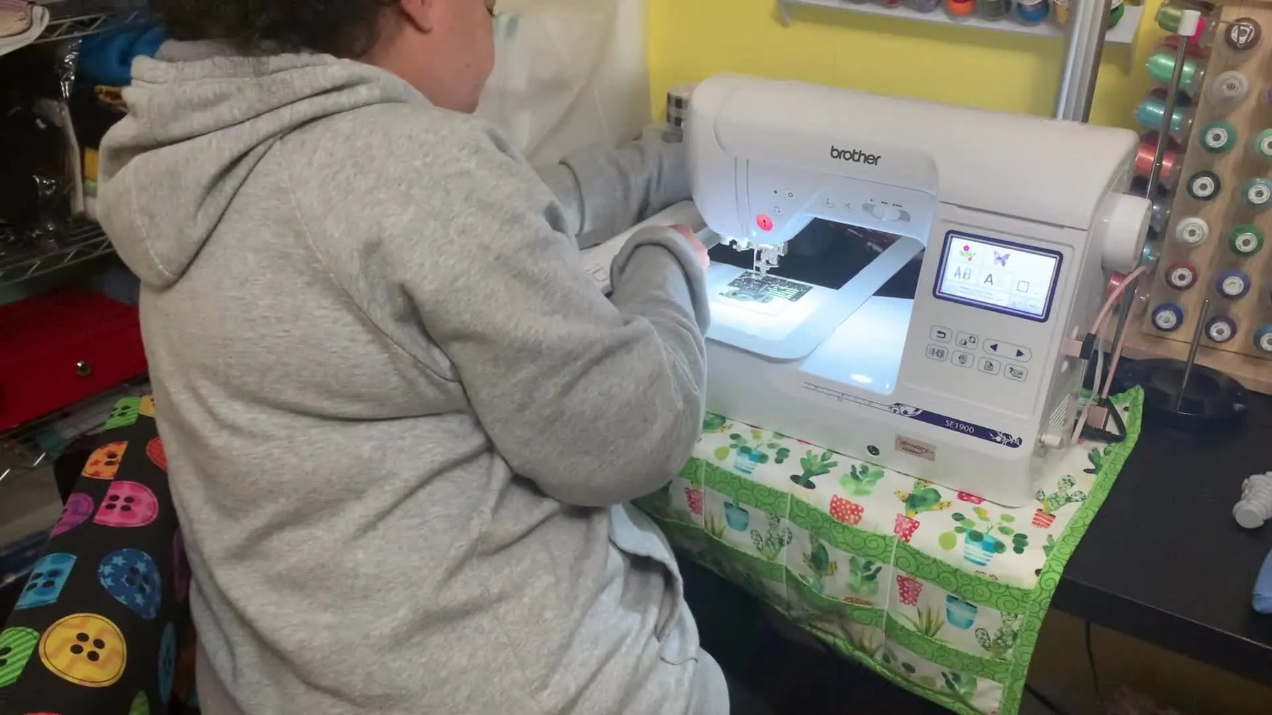 The 5x12 magnetic repositional hoop is mounted on the Brother SE1900 embroidery arm, showing how it slides in with generous clearance.