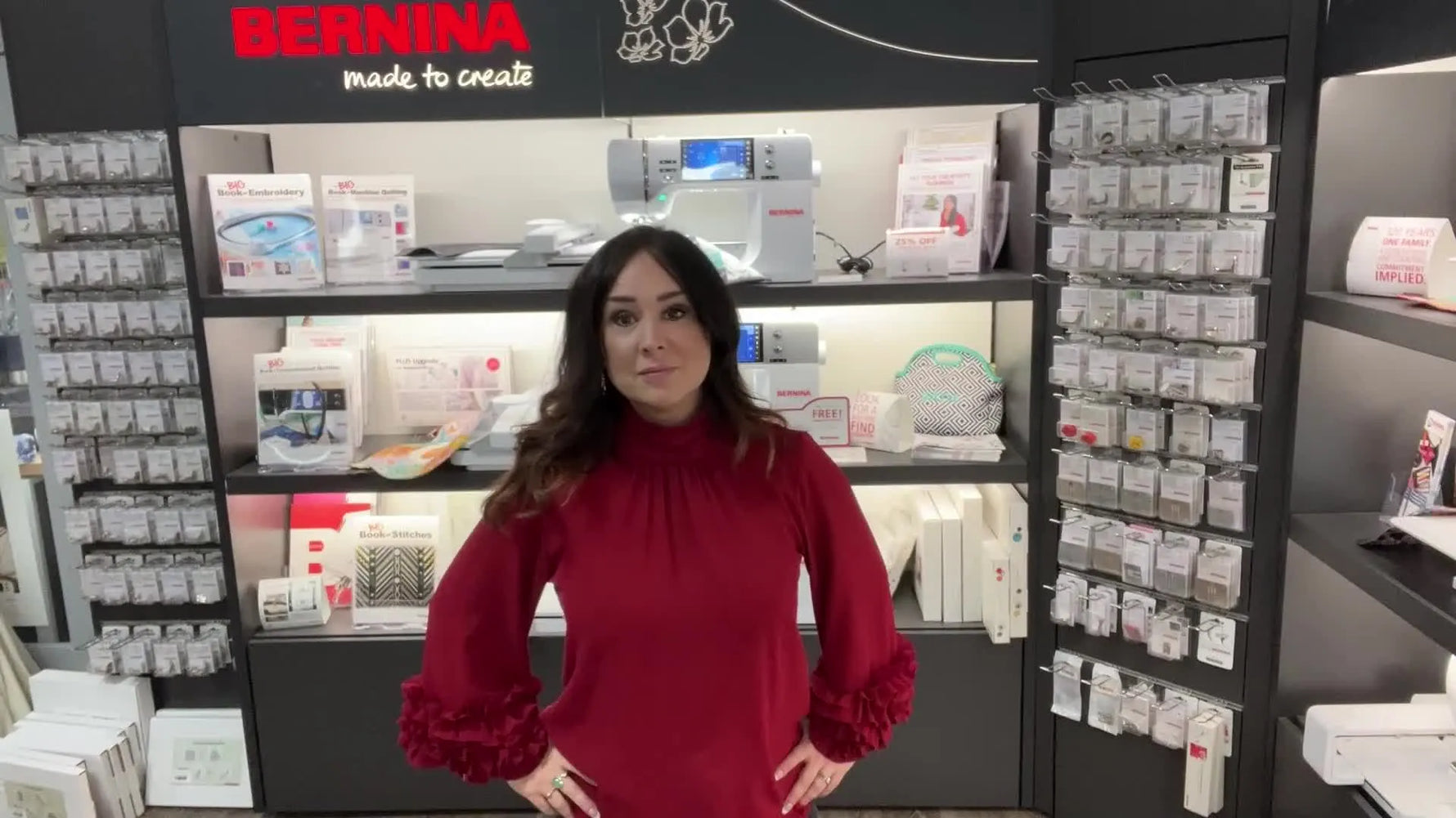 Woman in red shirt stands in front of Bernina store display.