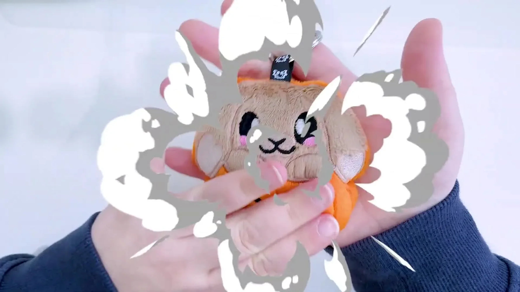 A close-up of the finished bunny-in-pumpkin plush keychain, showing crisp facial details and a neat ribbon loop ready for a keyring.