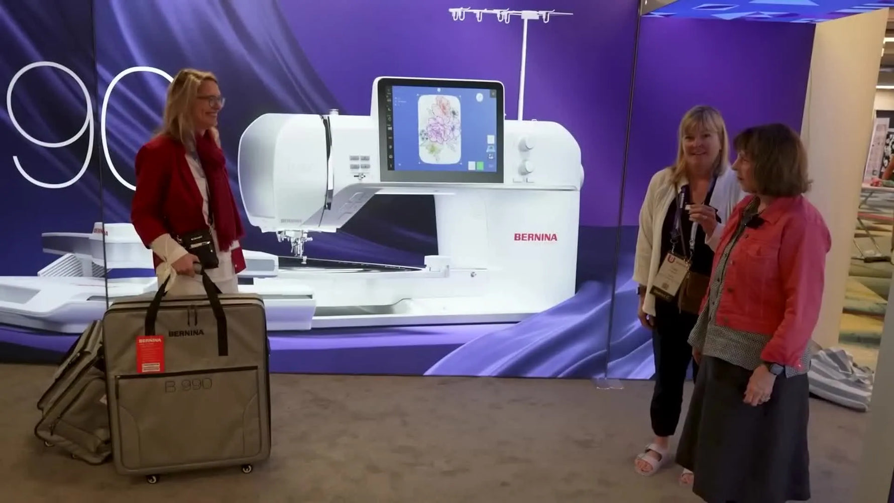 A wide shot of the Bernina B 990 being unveiled alongside its matching wheeled luggage system.