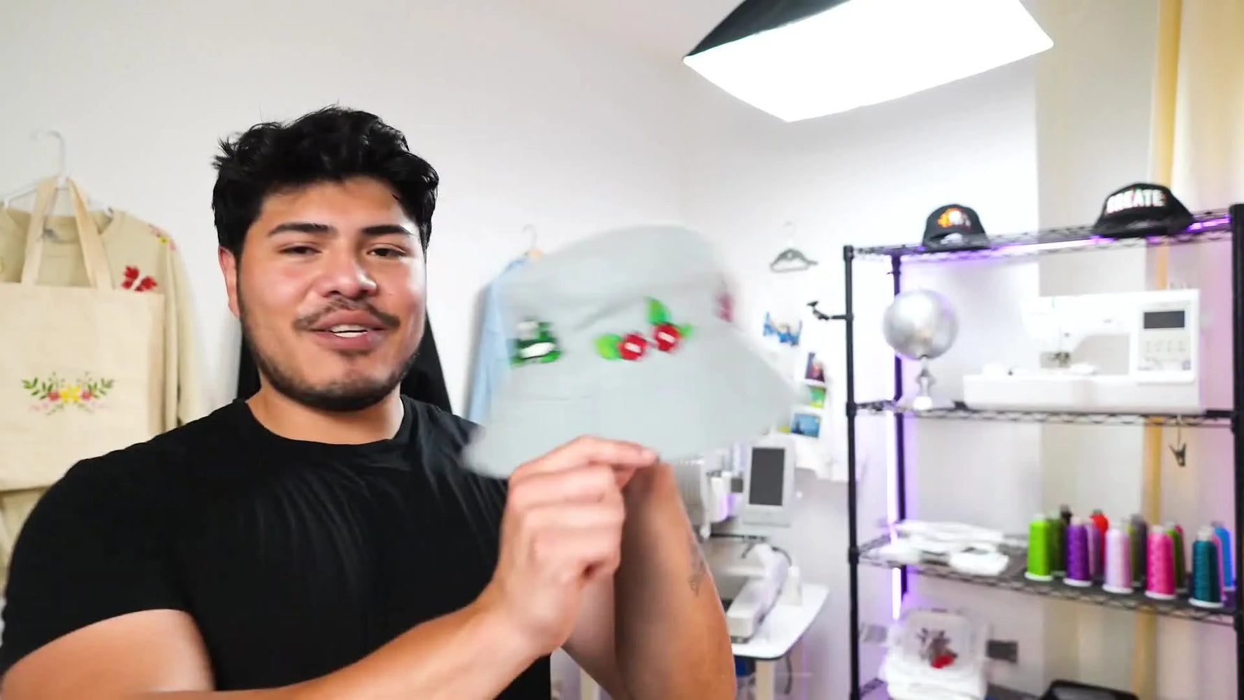Man showing an embroidered bucket hat