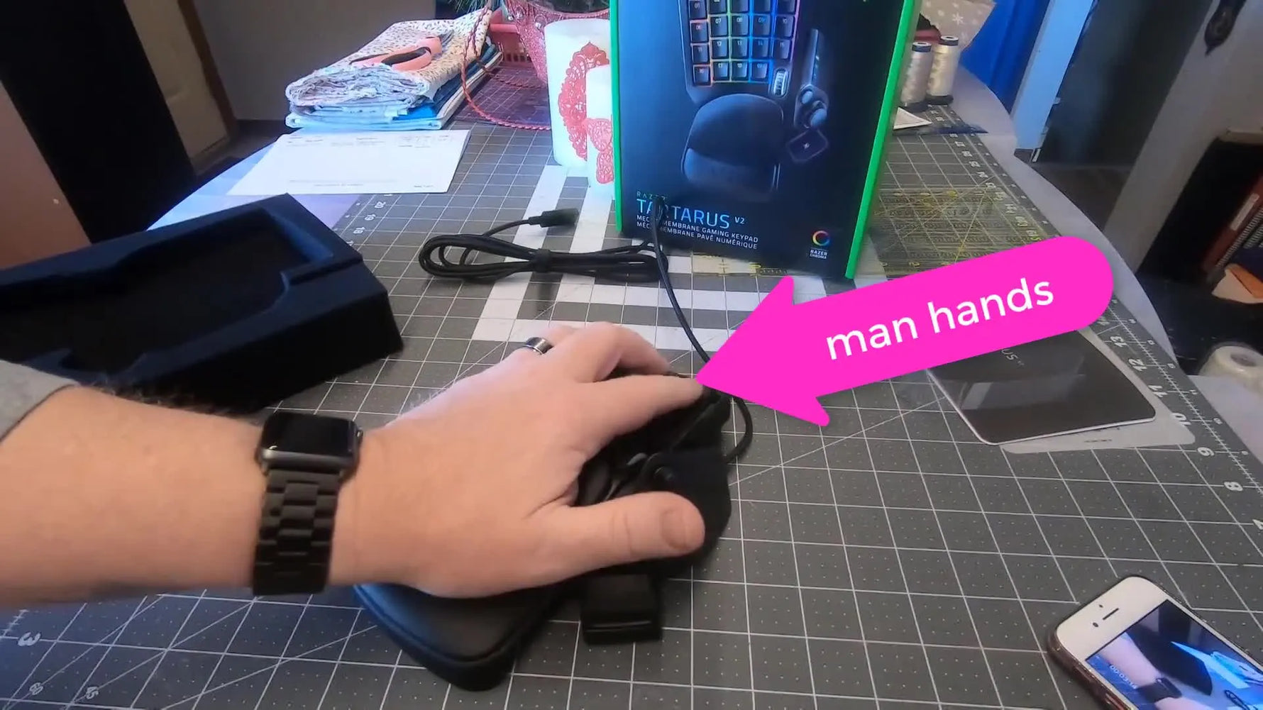 A larger hand rests on the Razer Tartarus v2 to show the most comfortable reach and key access during digitizing.