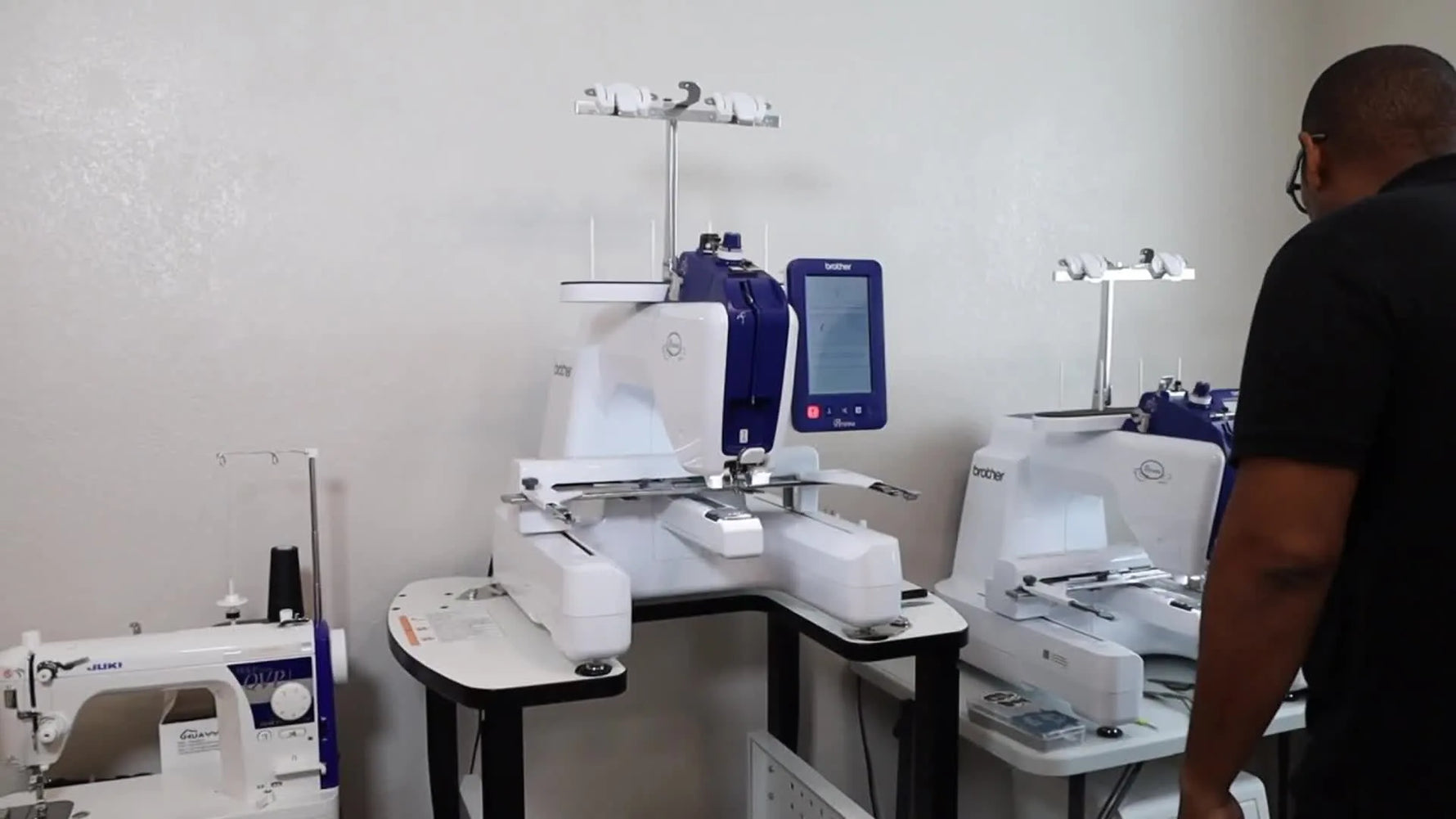 A full view of the Brother Persona PRS100 mounted on a dedicated stand, ready for production-style embroidery work.