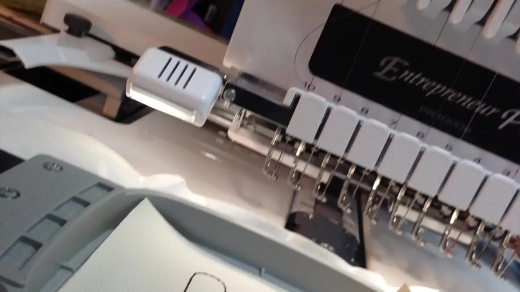 A close-up of the Brother PR1000e stitching the final triple-stitch border while the split ring sits safely positioned inside the hoop.