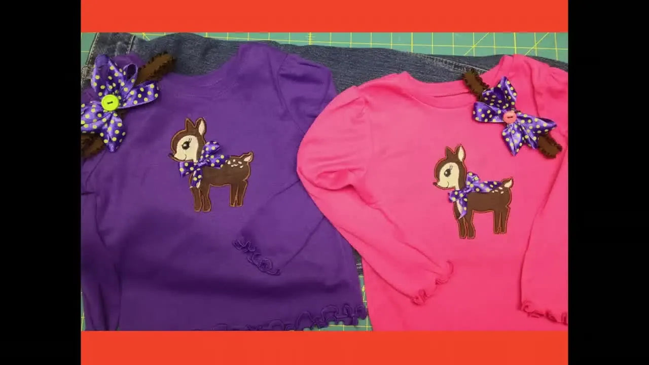 Two finished child T-shirts show a clean deer appliqué placement and a smooth knit surface with no visible hoop marks.