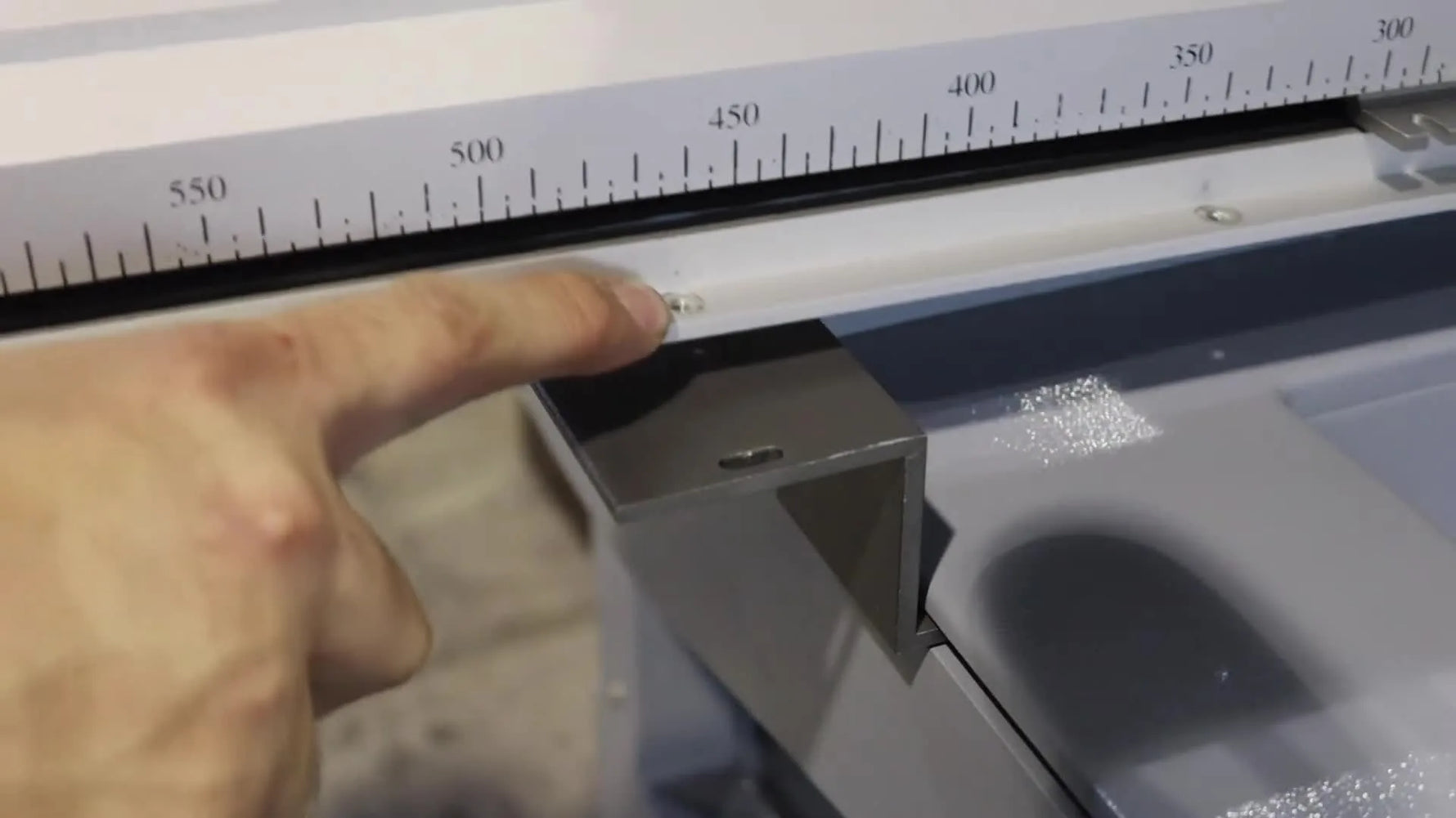 A close-up shows the pantograph bar hole being aligned precisely with the receiving nut on the machine’s mounting bracket.