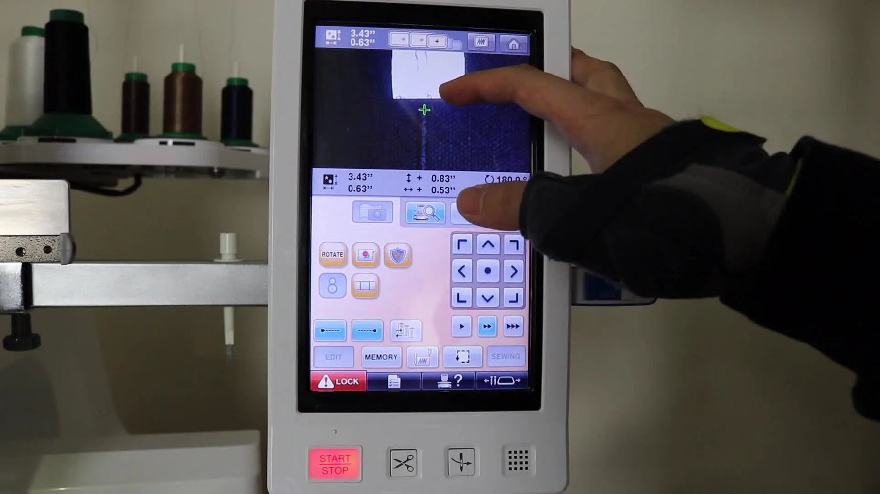 A close-up of the Baby Lock Enterprise touchscreen camera view as the crosshair is aligned to the end of the previously stitched rope for a precise split-hoop join.