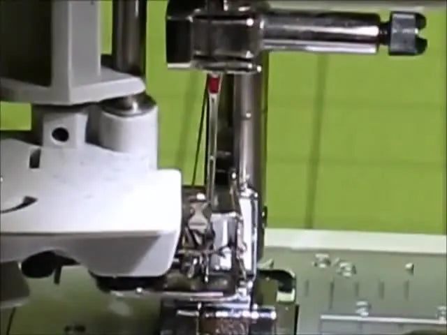 A close-up shows the Brother SE-400 automatic needle threader lever fully depressed as the hook pushes a loop of thread through the needle eye.