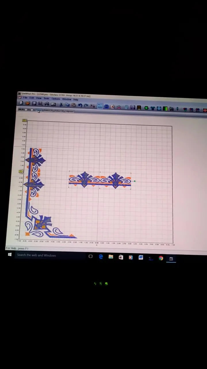 A full L-shaped border layout displayed on a large virtual 14x14 grid in SewWhat‑Pro, ready to be split into smaller hoop files.