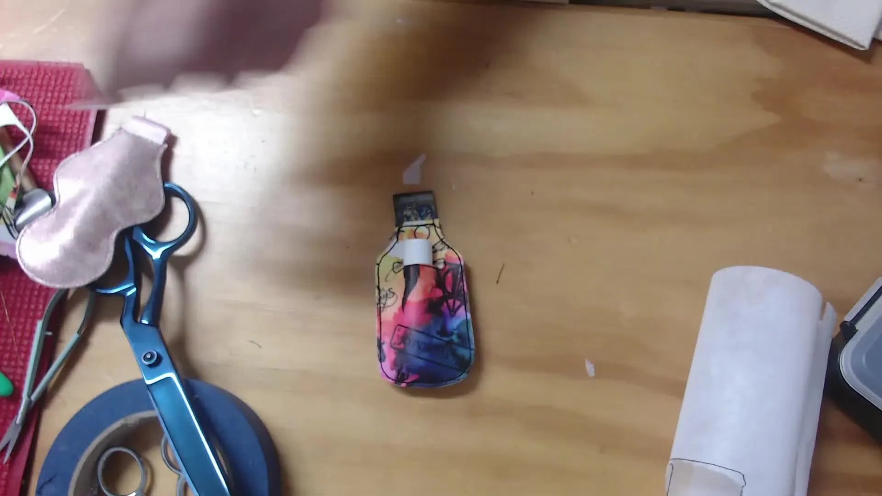 A finished vinyl lip balm holder is shown with a lip balm inserted to demonstrate fit and how securely the pocket holds.