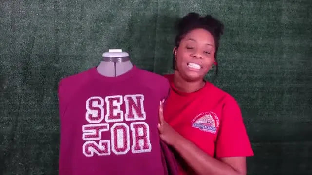A finished maroon fleece sweatshirt on a mannequin featuring a silver glitter “SENIOR” appliqué with a vertical “24” in place of the “I.”