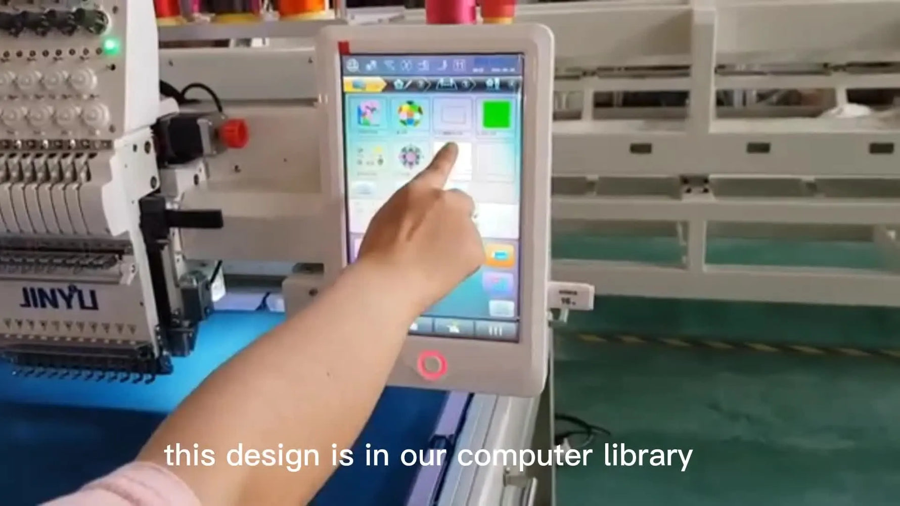 Hand selecting an embroidery design on a touchscreen