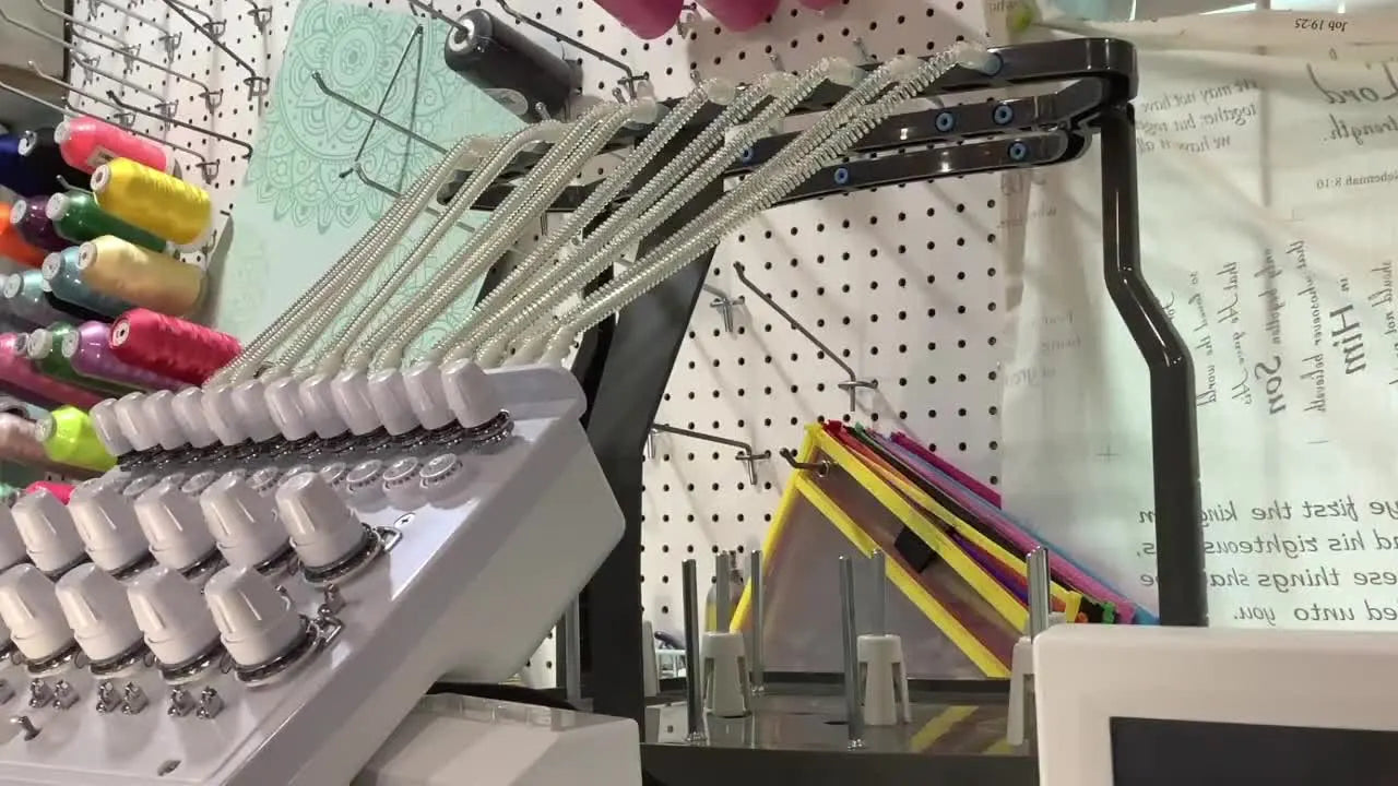 An overhead view of the SWF thread stand with an on-screen overlay labeling rows 1–5 to make cone placement and thread paths unmistakable.
