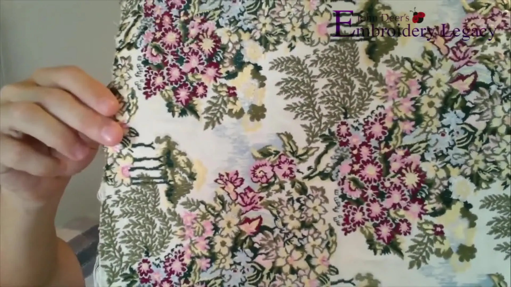 A crisp close-up of the vintage floral embroidery stitched on canvas, showing the short, upholstery-safe stitch structure.