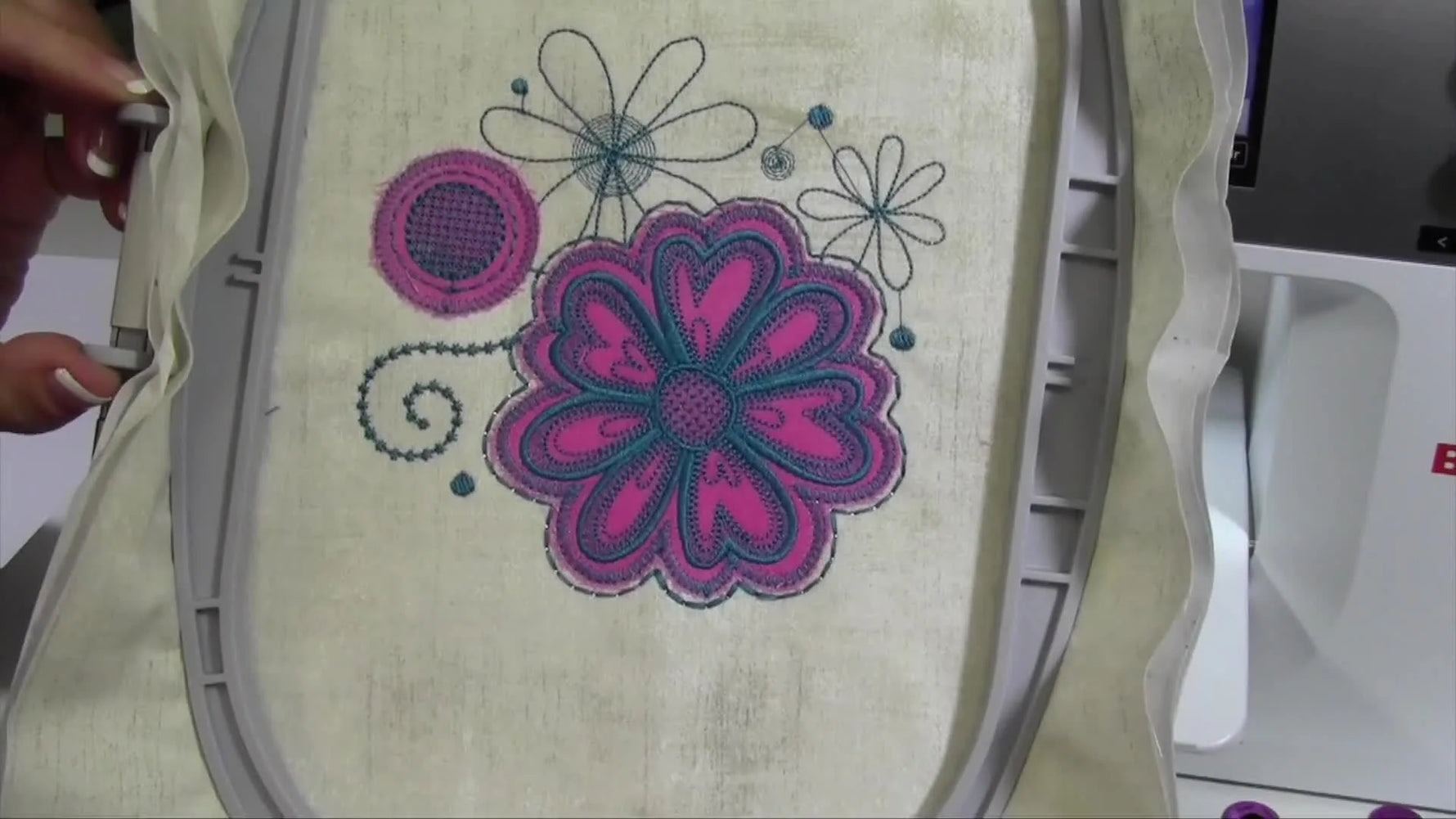 A finished Bernina 770 QE appliqué sample showing a circle and flower with a raw-edge look in the hoop.