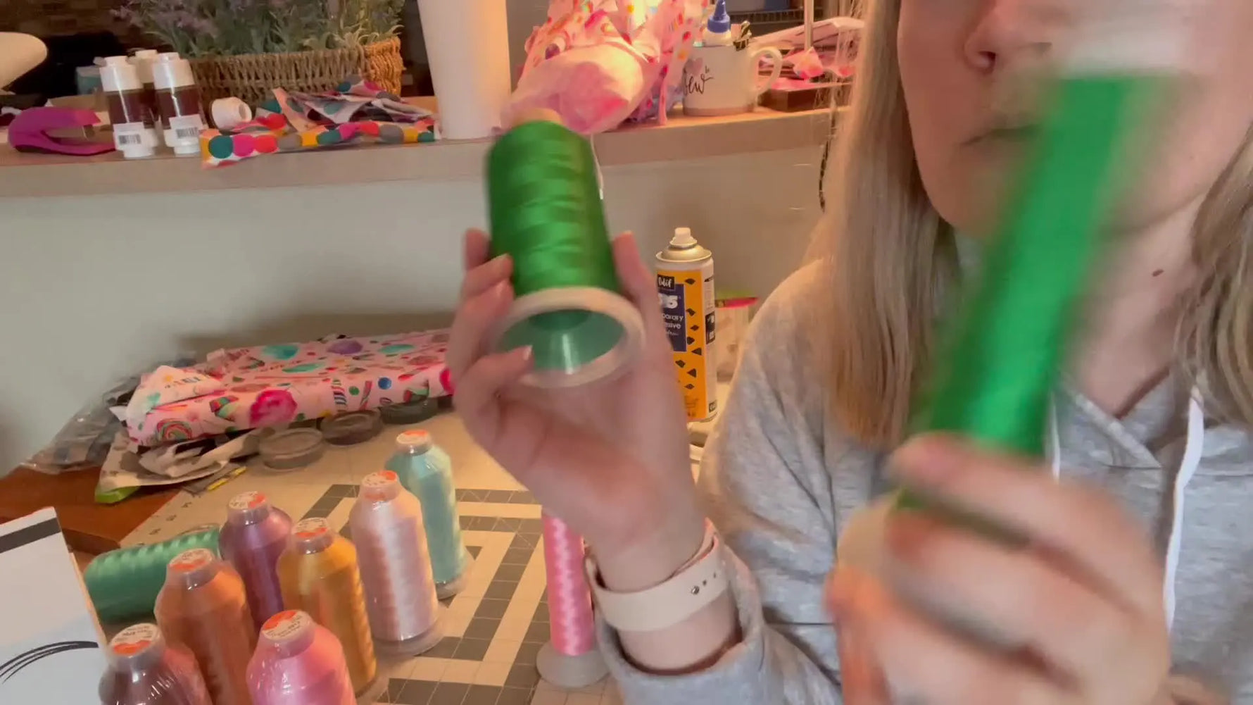 A close-up, side-by-side view of two green 5000-meter thread cones being compared under the same light.