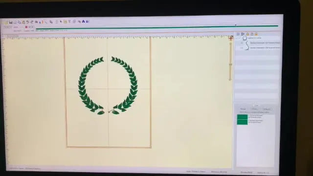 A finished Embrilliance Essentials preview showing a dark green wreath with a red bow after color stops were inserted to remove a long jump stitch.