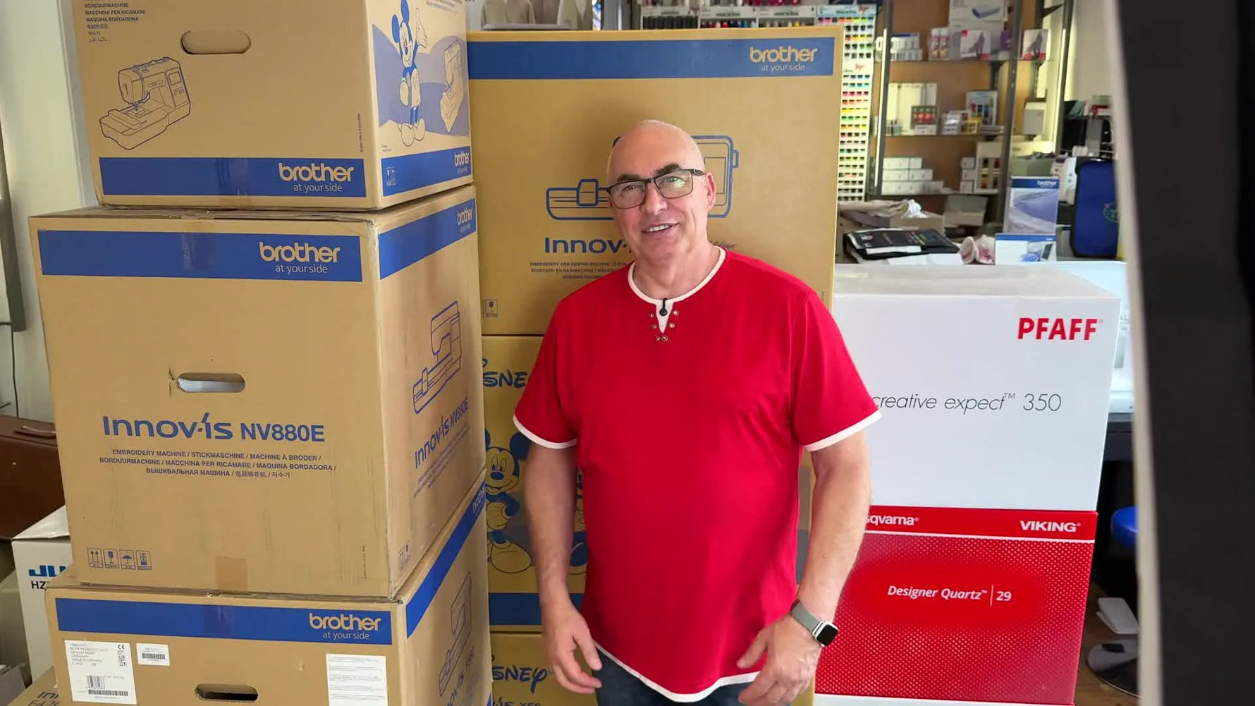 A presenter stands in front of stacked embroidery machine boxes, introducing a series about choosing the right embroidery setup.
