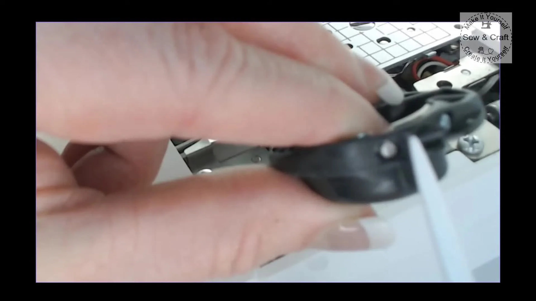 A close-up of a screwdriver turning the bobbin-case tension screw using the “15 minutes on a clock face” method.