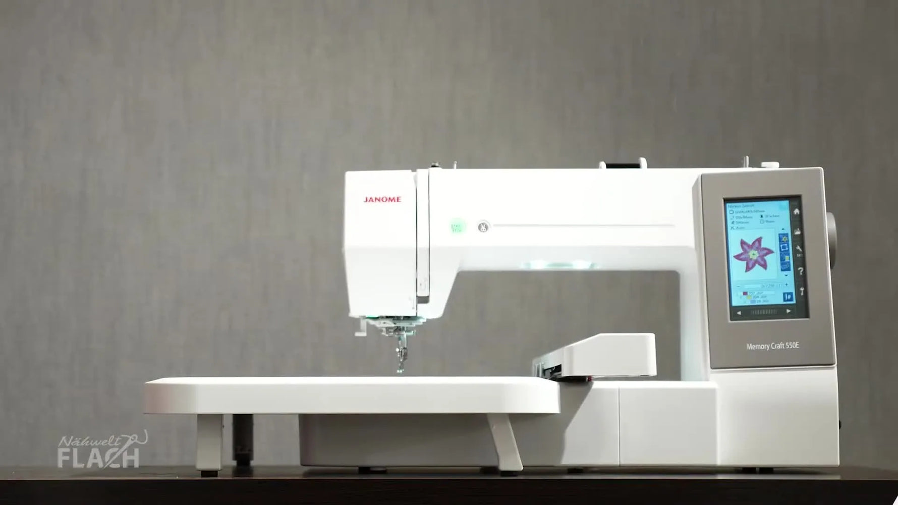 A Janome Memory Craft 550E embroidery machine sits ready on a worktable, setting the stage for a clean USB-to-machine workflow.