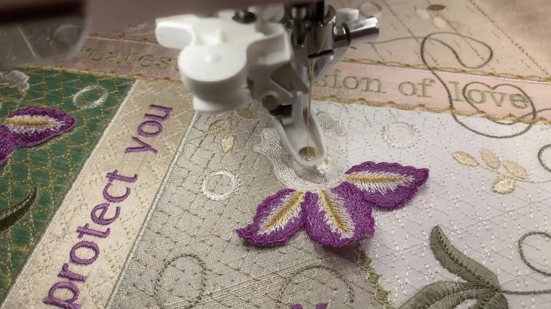 A close-up of the embroidery machine tacking down the center of a white 3D iris lace piece in the hoop, showing the exact moment the flower is locked in place.