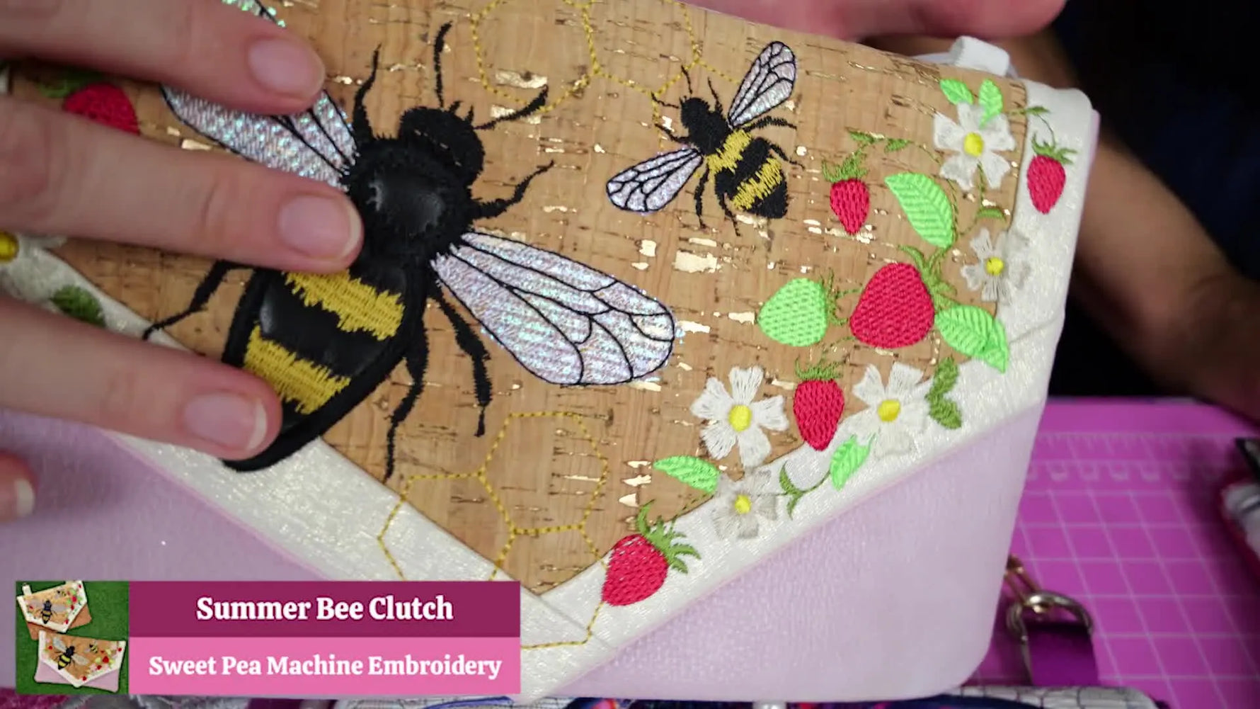 A close-up of the Summer Bee Clutch in cork fabric, showing crisp embroidery details and a polished, boutique-style finish.