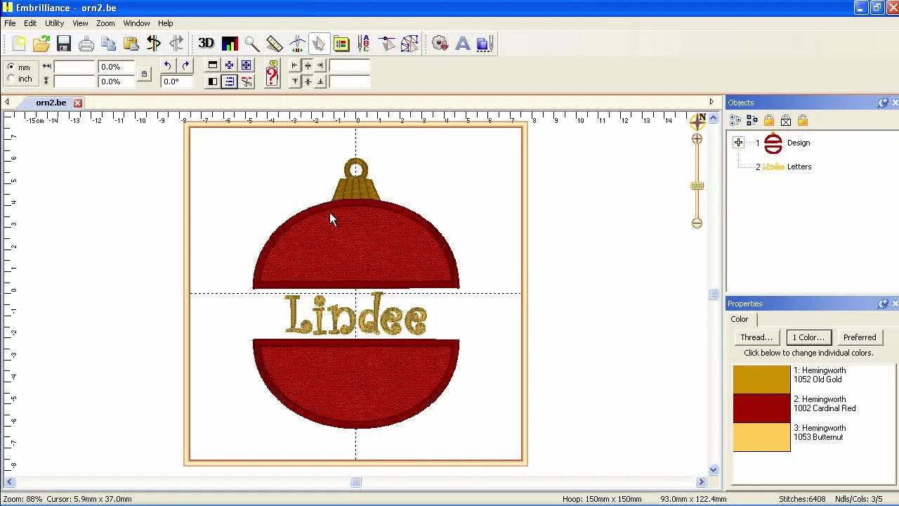 A finished red-and-gold appliqué ornament design with centered name lettering displayed inside the Embrilliance interface.