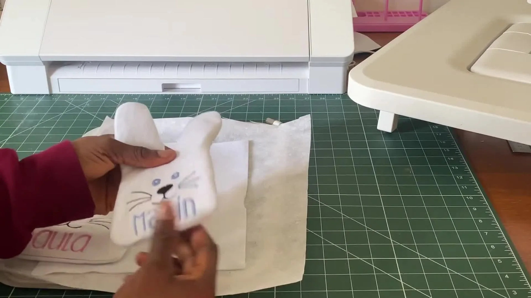 Three finished white felt ITH Easter bunny treat bags in different sizes are displayed side by side, each personalized with a name.