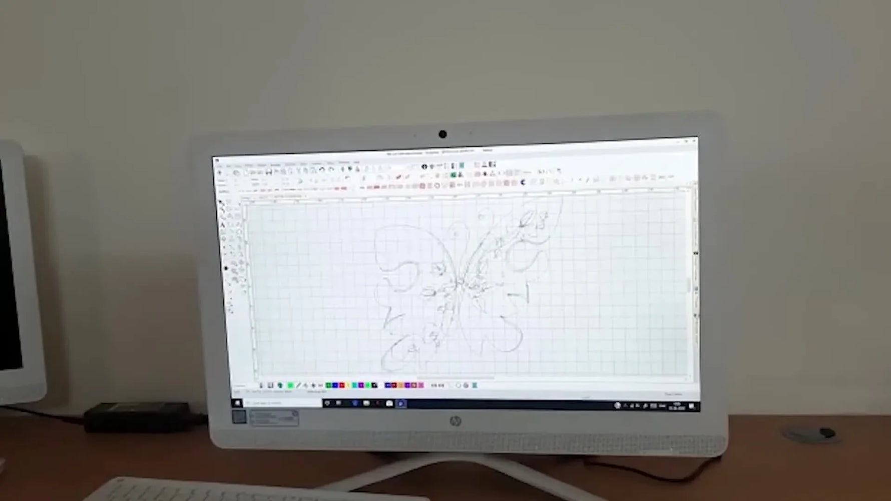 A Wilcom screen capture shows a butterfly wing being filled with a dense spiral stitch pattern to create a 3D visual effect.