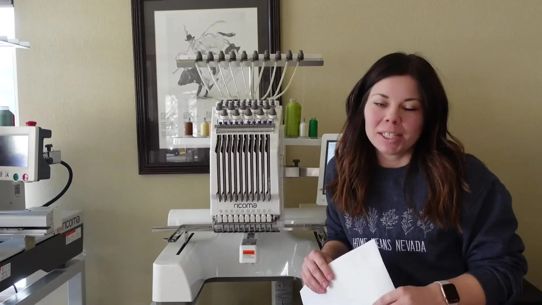 Woman smiling in front of Ricoma embroidery machine.