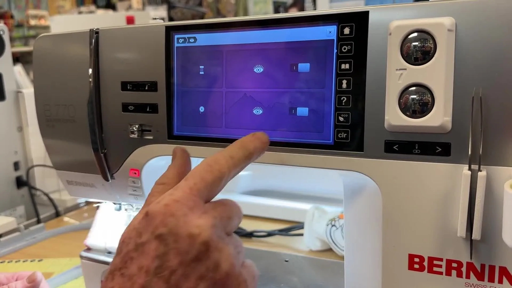 The Bernina 770 QE touchscreen shows the lower thread sensor toggle being switched to Off in the Monitoring menu.