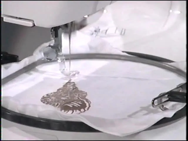 A close-up of the Kenmore 19000 stitching a detailed seashell embroidery design inside the hoop.
