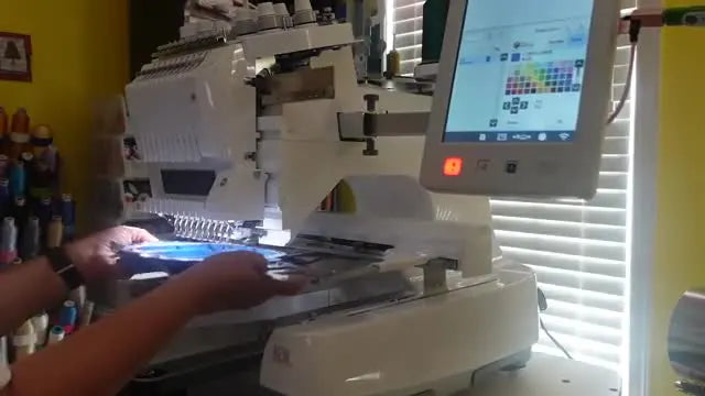 The Brother PR1055X screen recognizes the printed Snowman alignment mark on a paper template, showing red circles over the marker for precise placement.