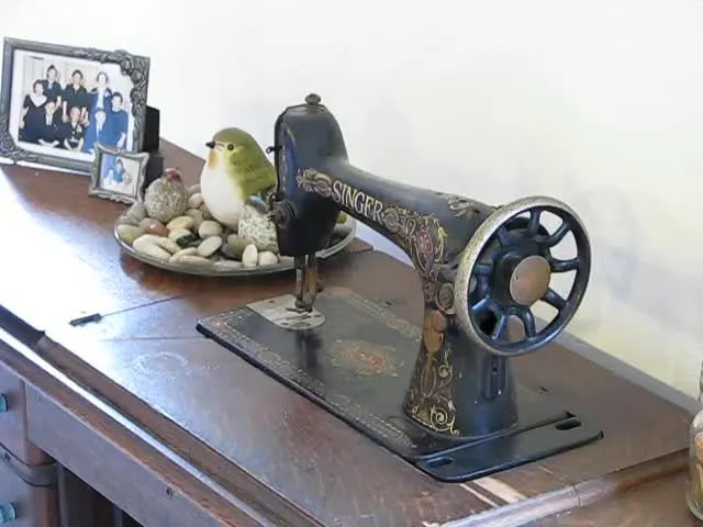 A close-up shows the operator pressing the inner ring into the outer ring on a hooping fixture to lock a T-shirt tightly and evenly before stitching.