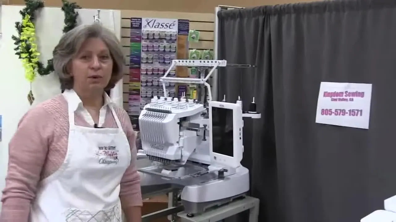 A wide shot of the Baby Lock Venture 10-needle embroidery machine set up for production work.