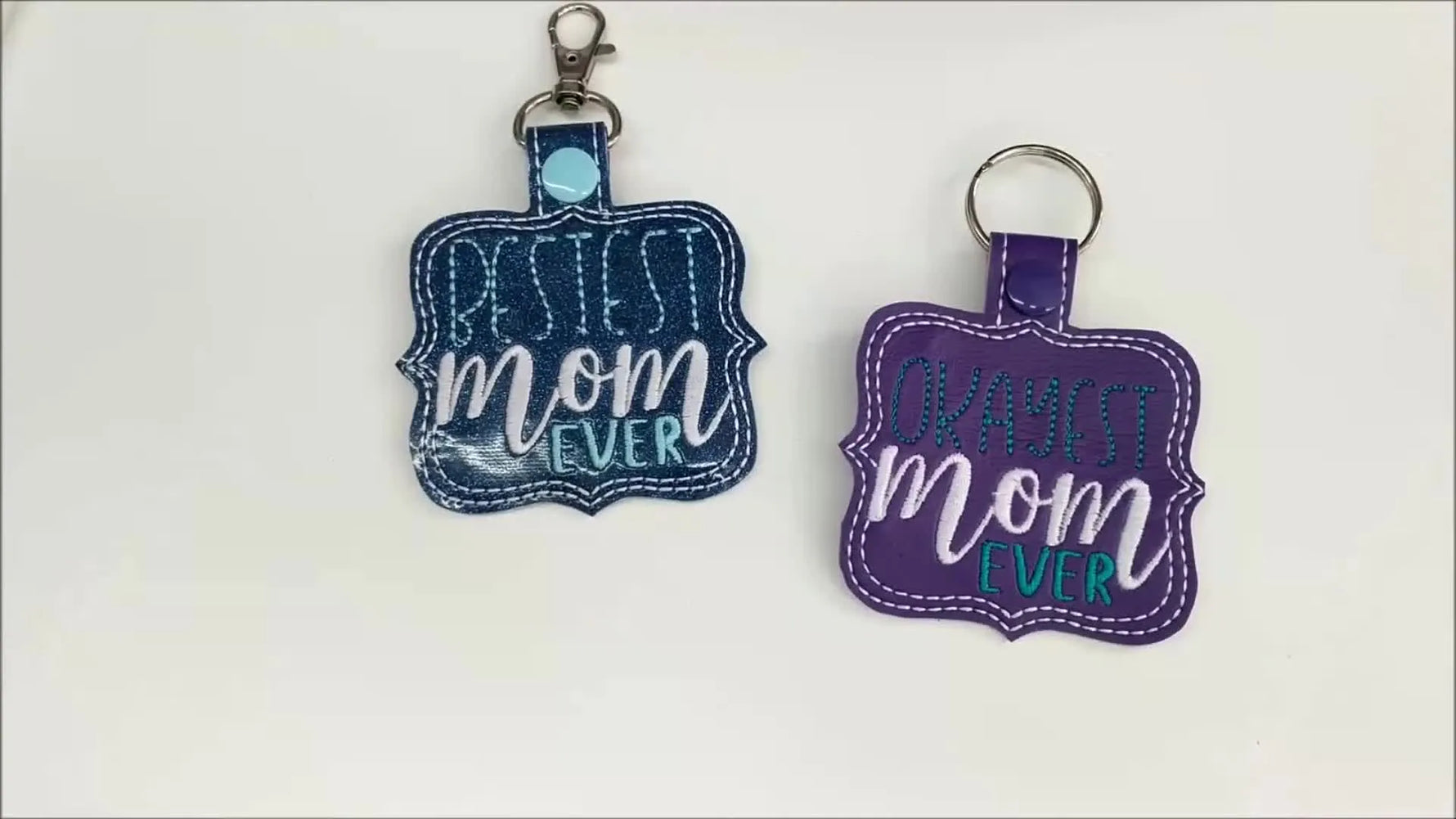 Two completed ITH Mother’s Day keychains—one teal and one purple—are displayed side by side as the final reveal.