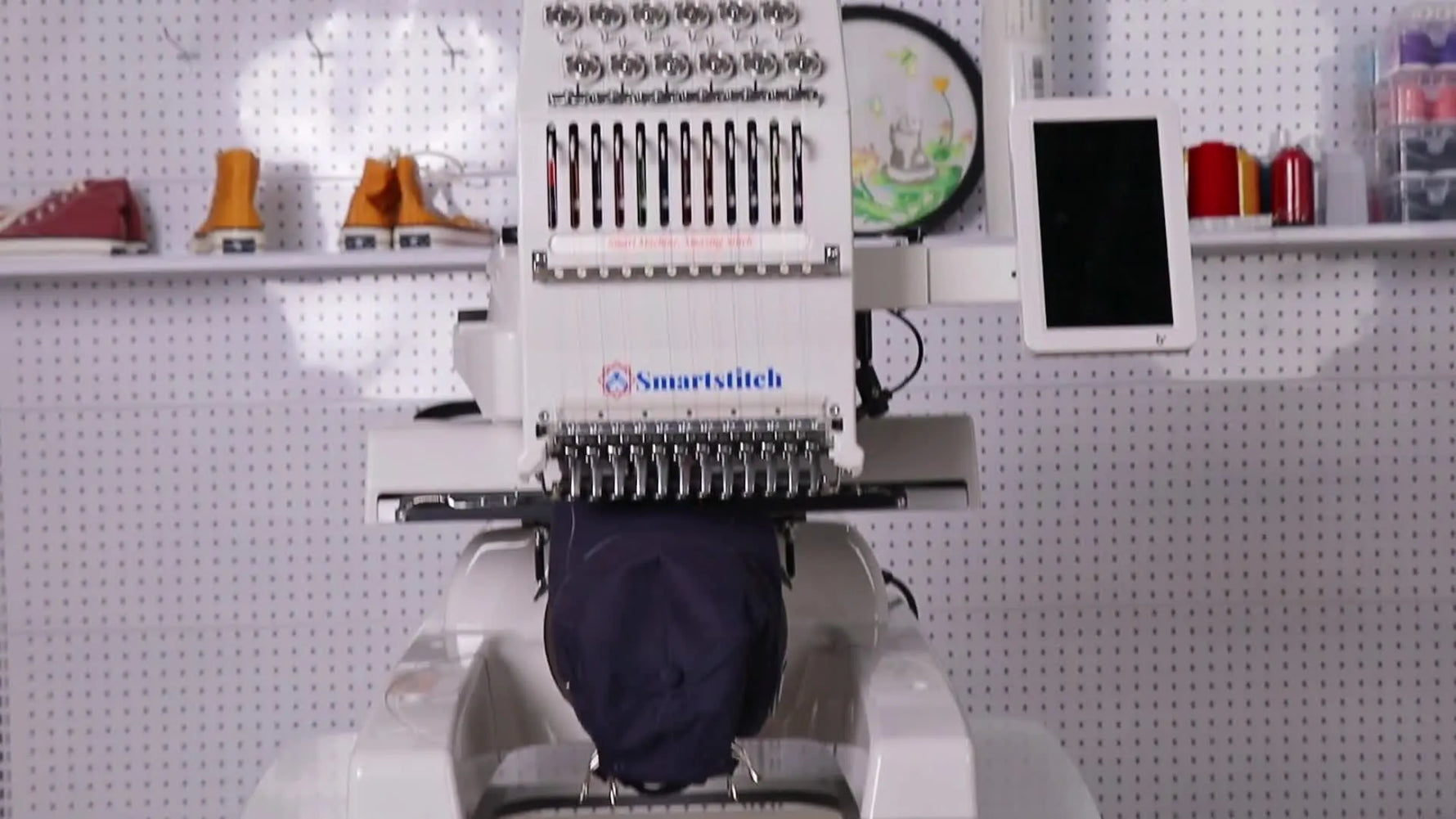 A full front view of the Smartstitch S1201 12-needle embroidery machine before the cap-to-flat conversion begins.