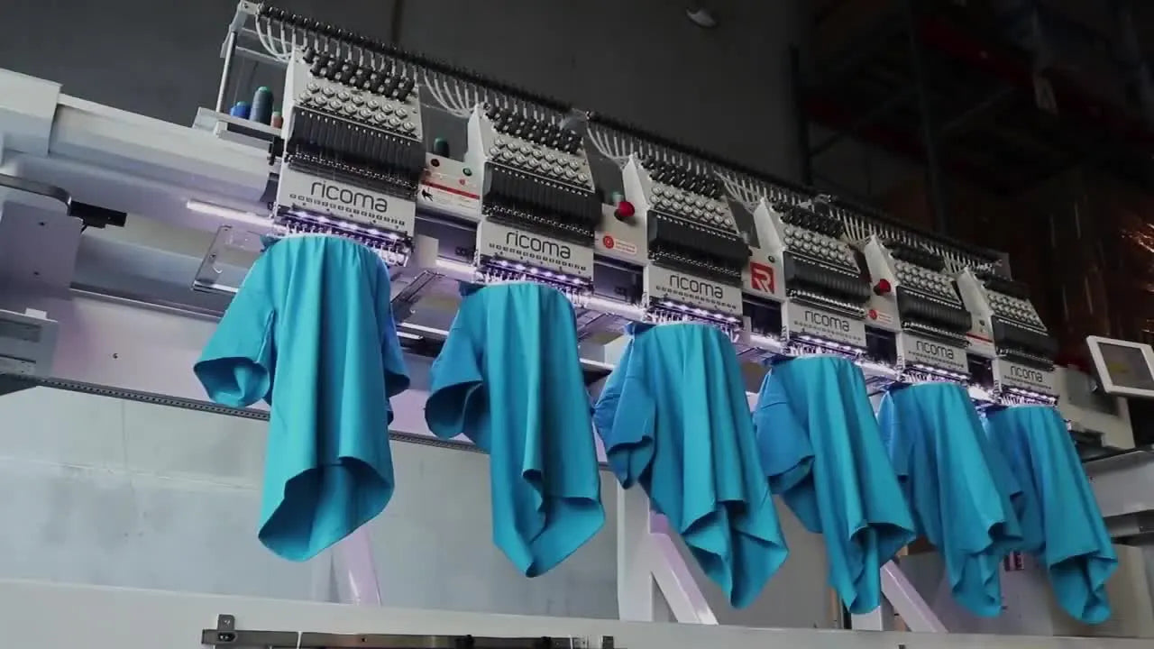A 6-head Ricoma CHT2 runs a synchronized production job on blue polo shirts, showing true multi-head throughput in action.