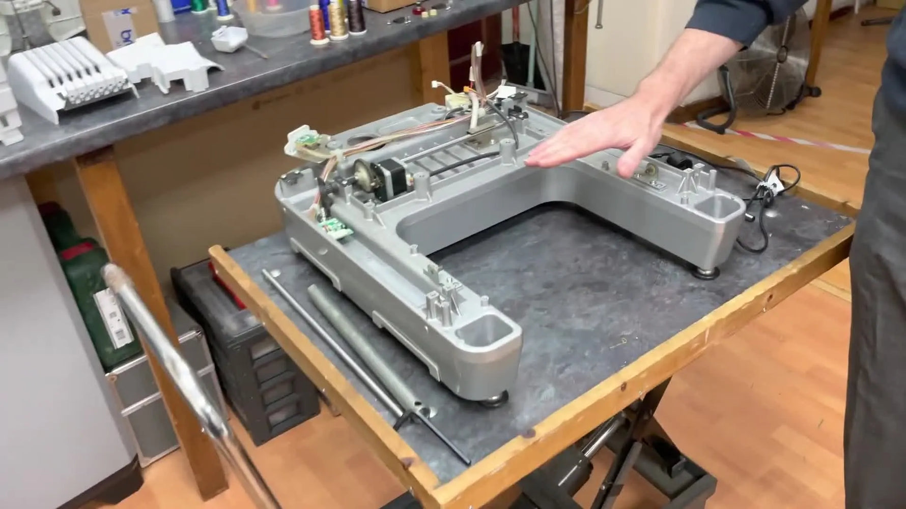 A Brother PR670 split open on the bench, showing the separated chassis and internal components during a major service job.
