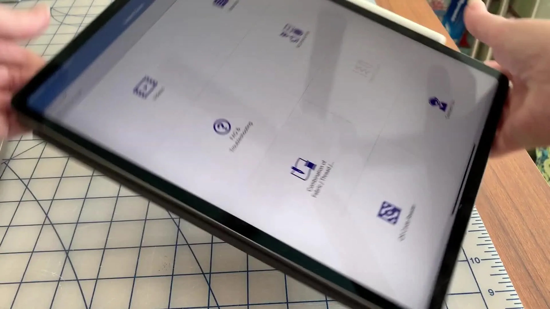 A close-up of the Brother Support Center app main menu on an iPad, showing icons for manuals, troubleshooting, and accessories.