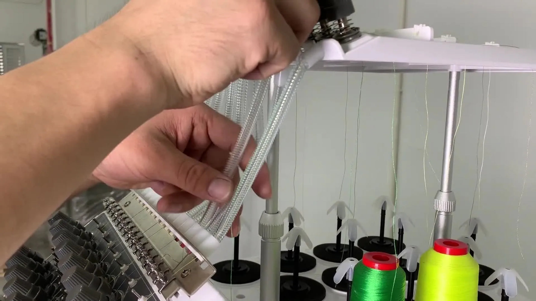 A close-up of the wire threading guide being inserted into the HM-1501 anti-wind tube to pull thread through cleanly.