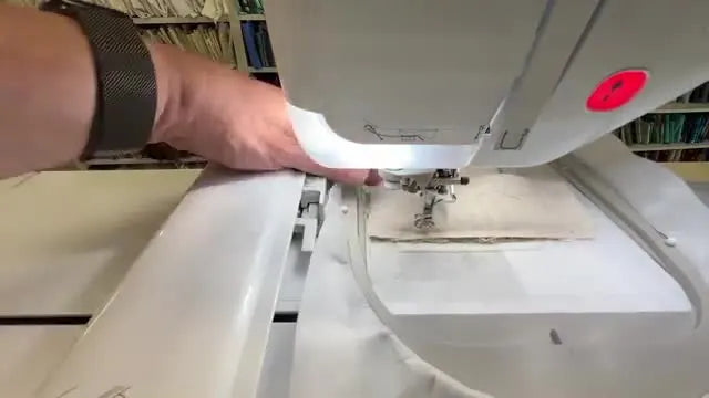 An overhead shot shows a rotary cutter and quilting ruler trimming the finished upper pocket panel to a clean, accurate 1/2-inch border.