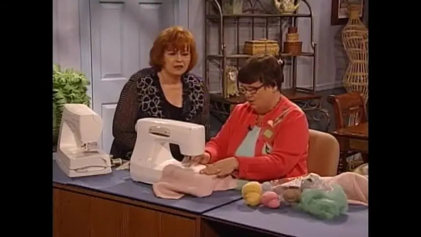 A close-up of a needle felting machine punching wool roving into fabric, highlighting precision surface embellishment in action.