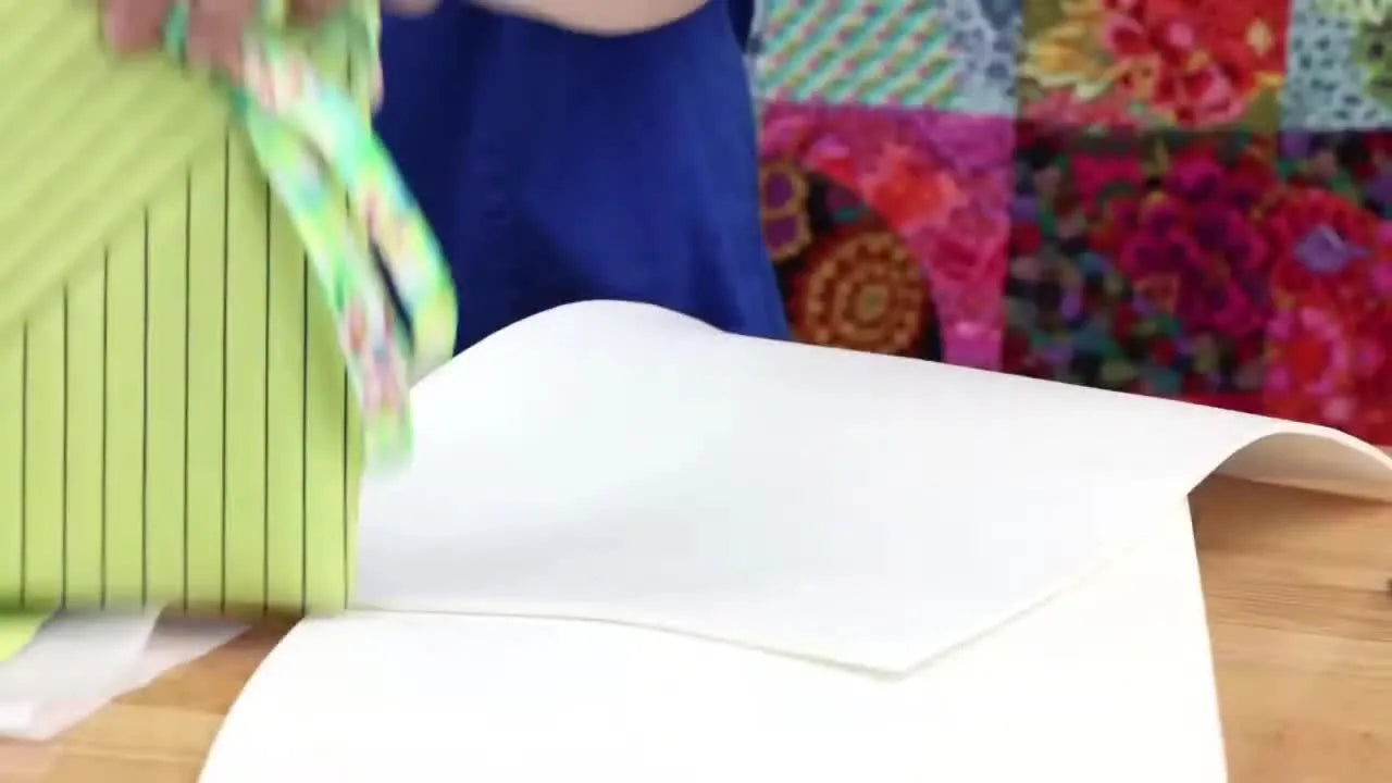 Close-up of a finished lime green vinyl bag with deep, puffed channel stitching and a chevron-style quilted texture.