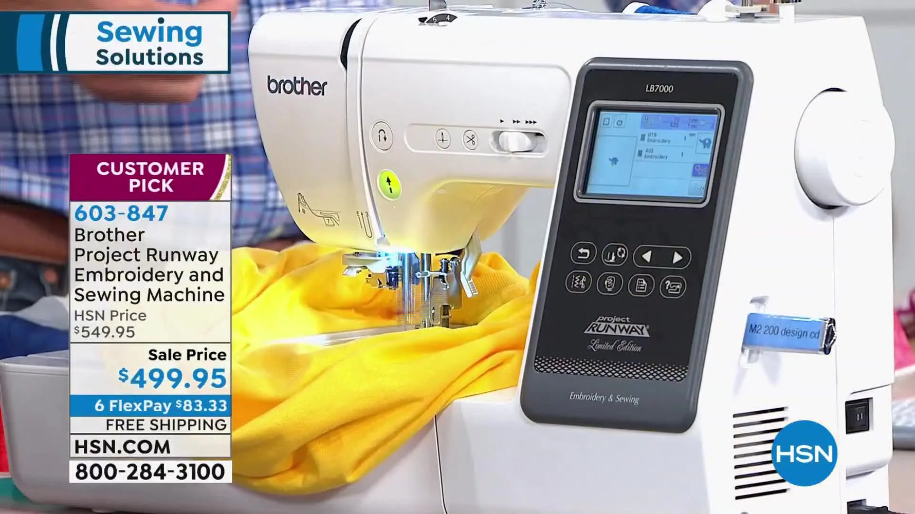 The Brother LB7000 is stitching a blue elephant design hands-free on a yellow T-shirt in the 4x4 hoop.